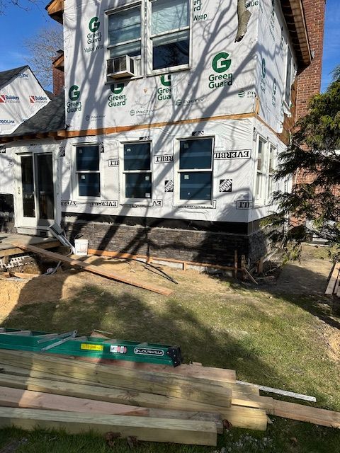 A house with a lot of windows is being remodeled.