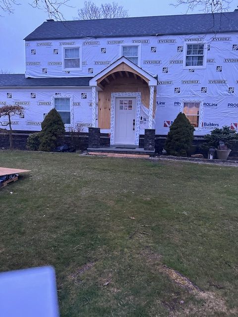 A house is being remodeled with a porch and a roof.