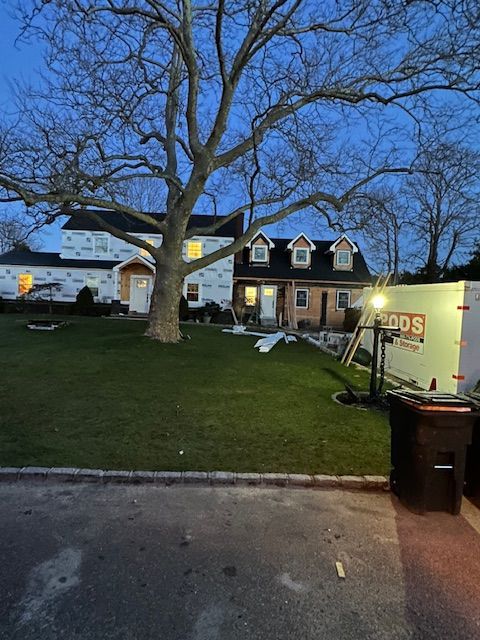 A large house with a large tree in front of it.
