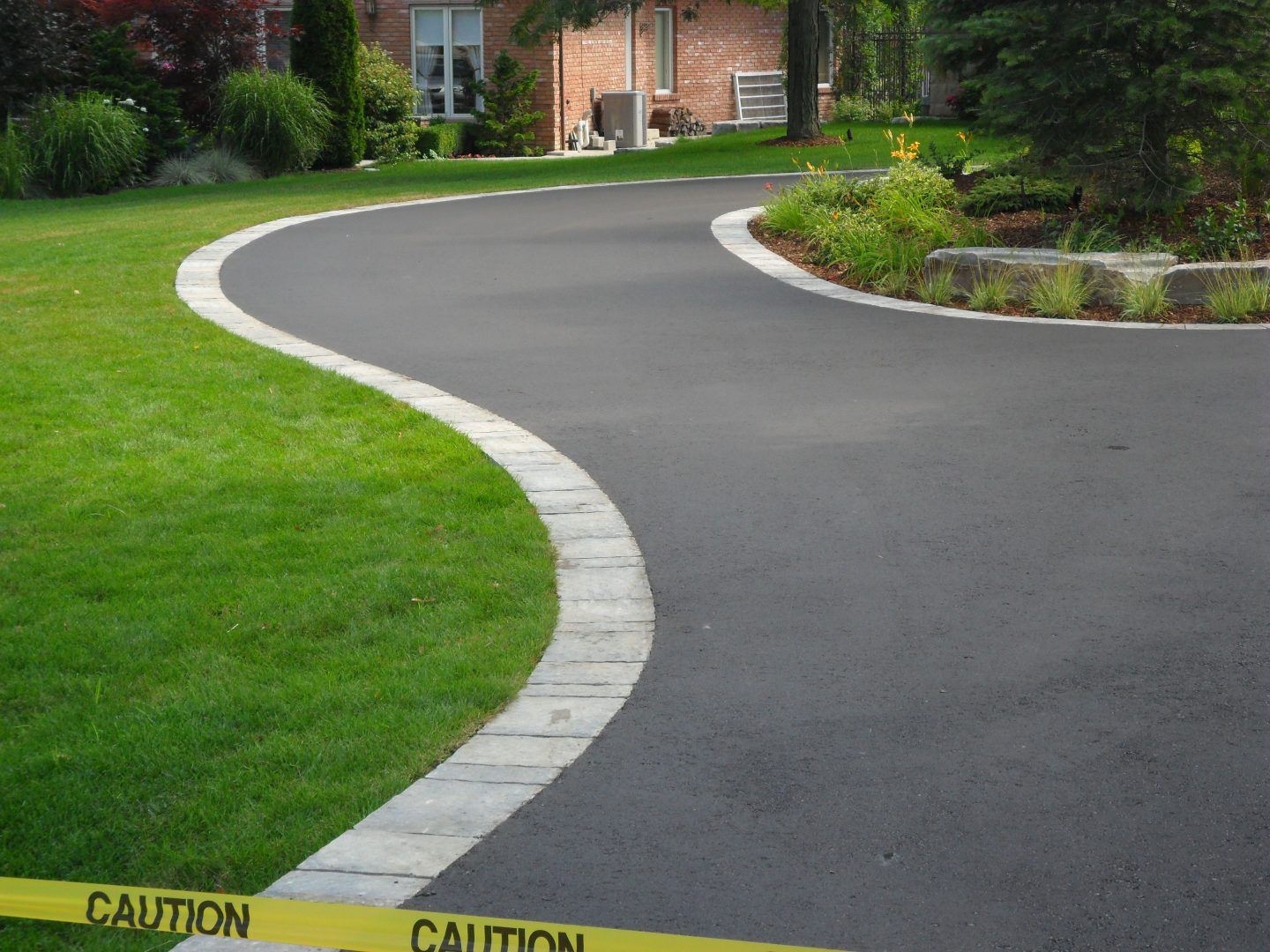 A caution tape is on the side of a road.