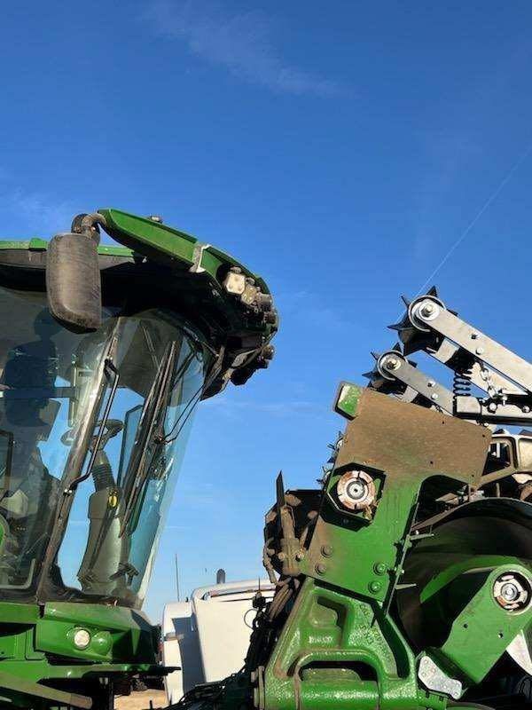 Two green tractors are parked next to each other.