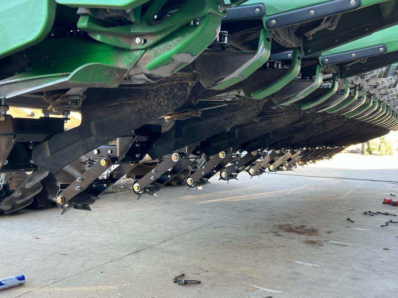 A green tractor is parked on the side of the road