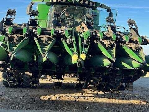 A green tractor is parked on the side of the road.