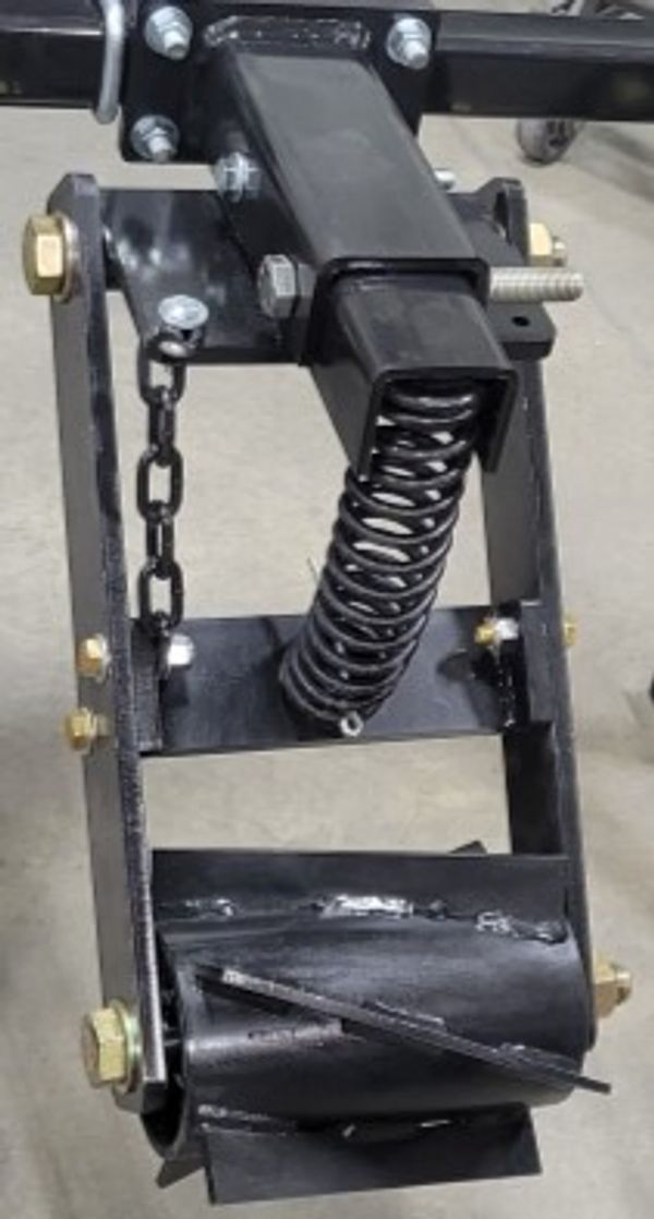 A close up of a metal object with a spring attached to it