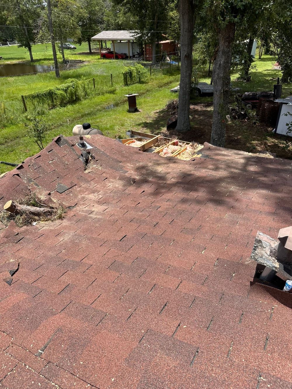 A roof with a lot of damage on it is being repaired.