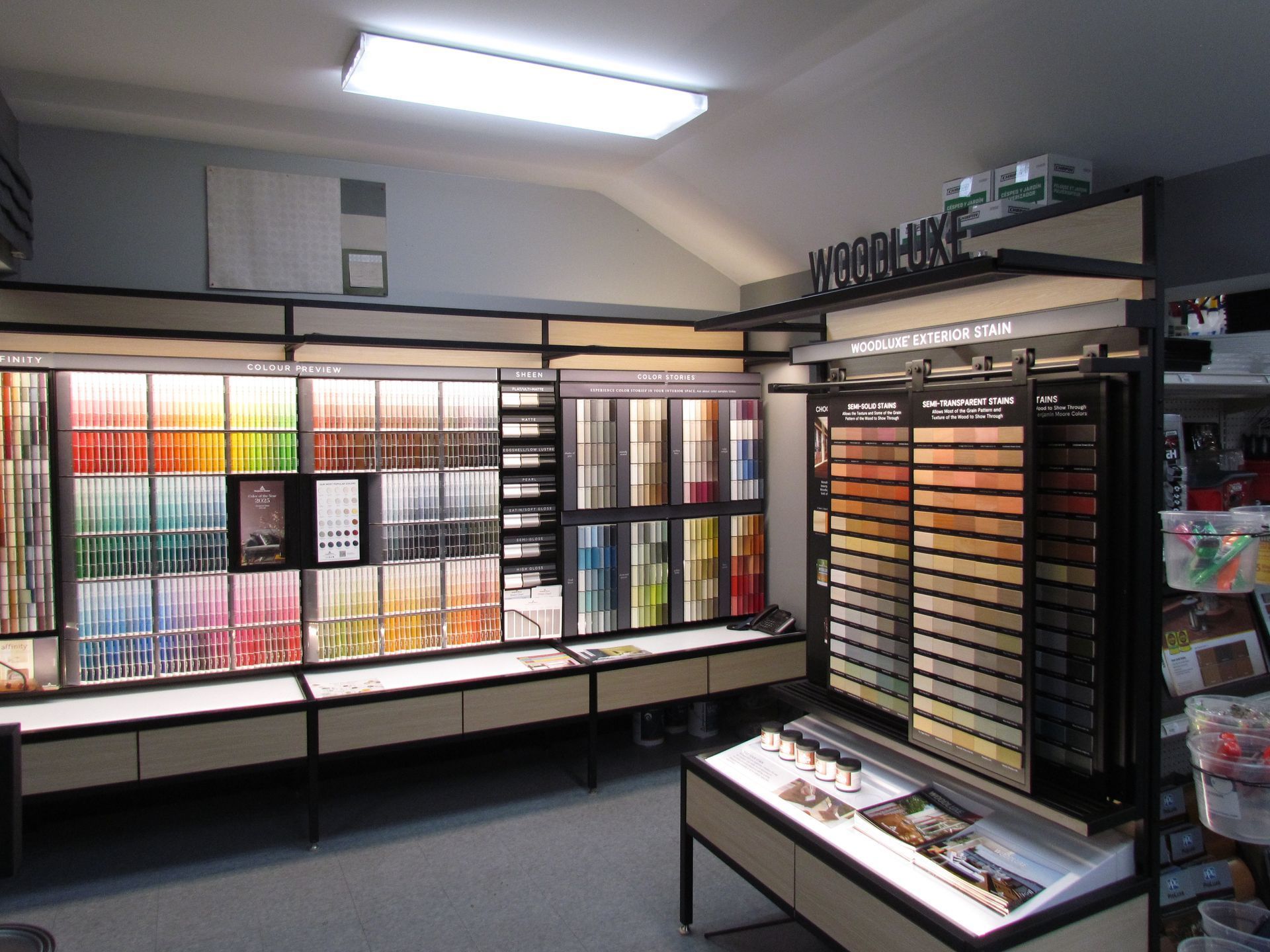 Paint store interior, showcasing various paint color swatches and displays under bright lighting.