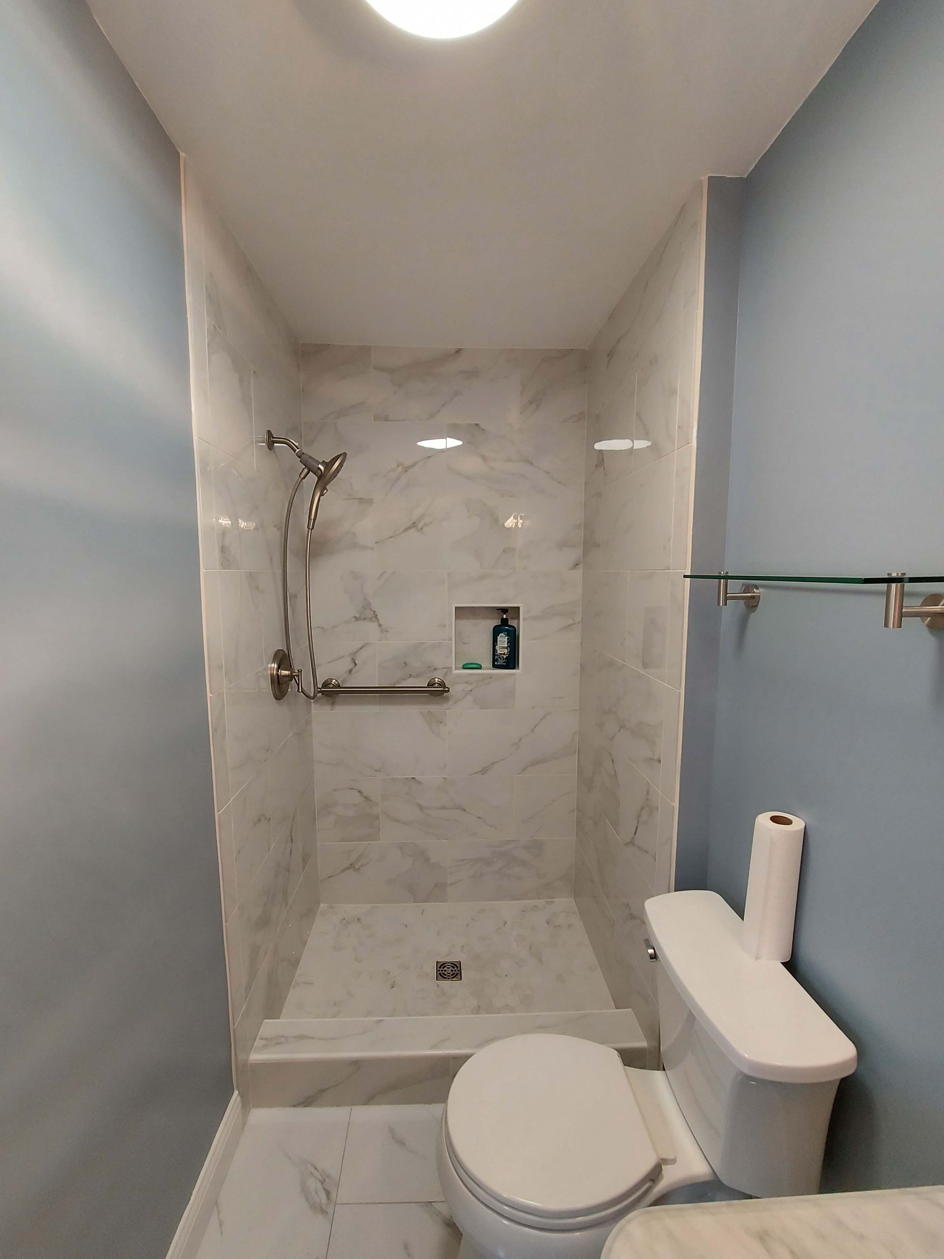 There is a toilet and a shower in the bathroom.