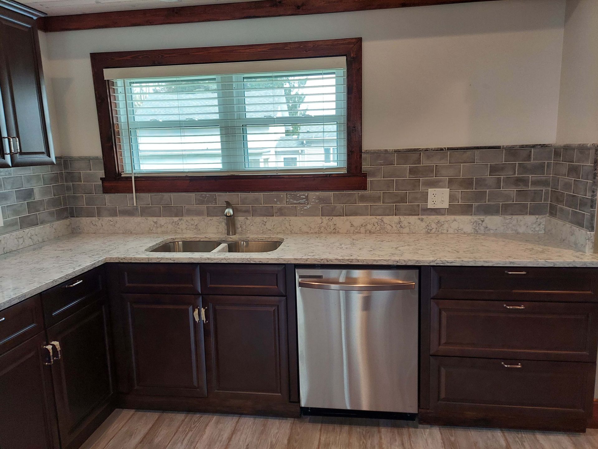 A kitchen with two sinks and a stainless steel dishwasher