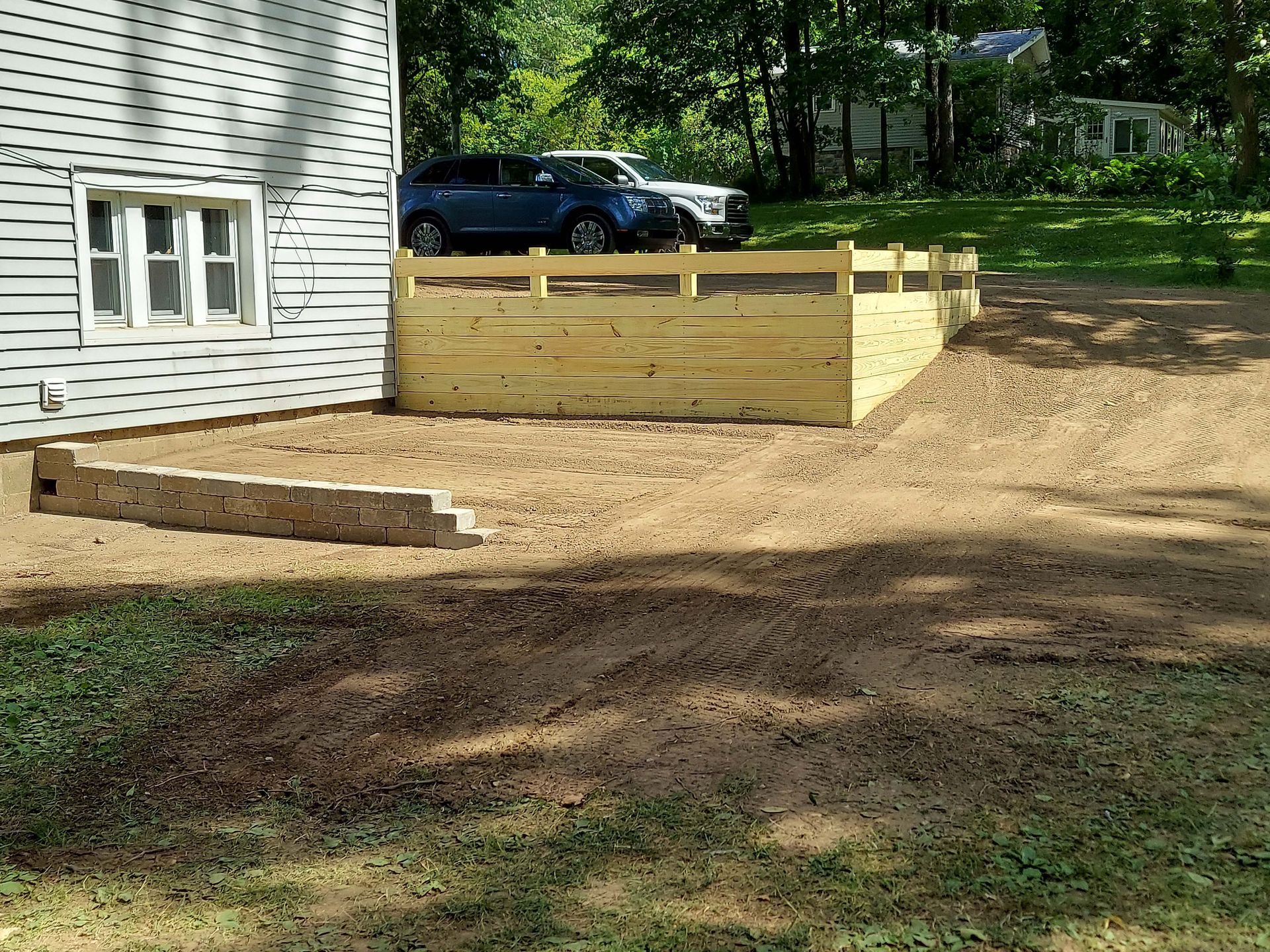 A white house with a wooden fence in front of it.