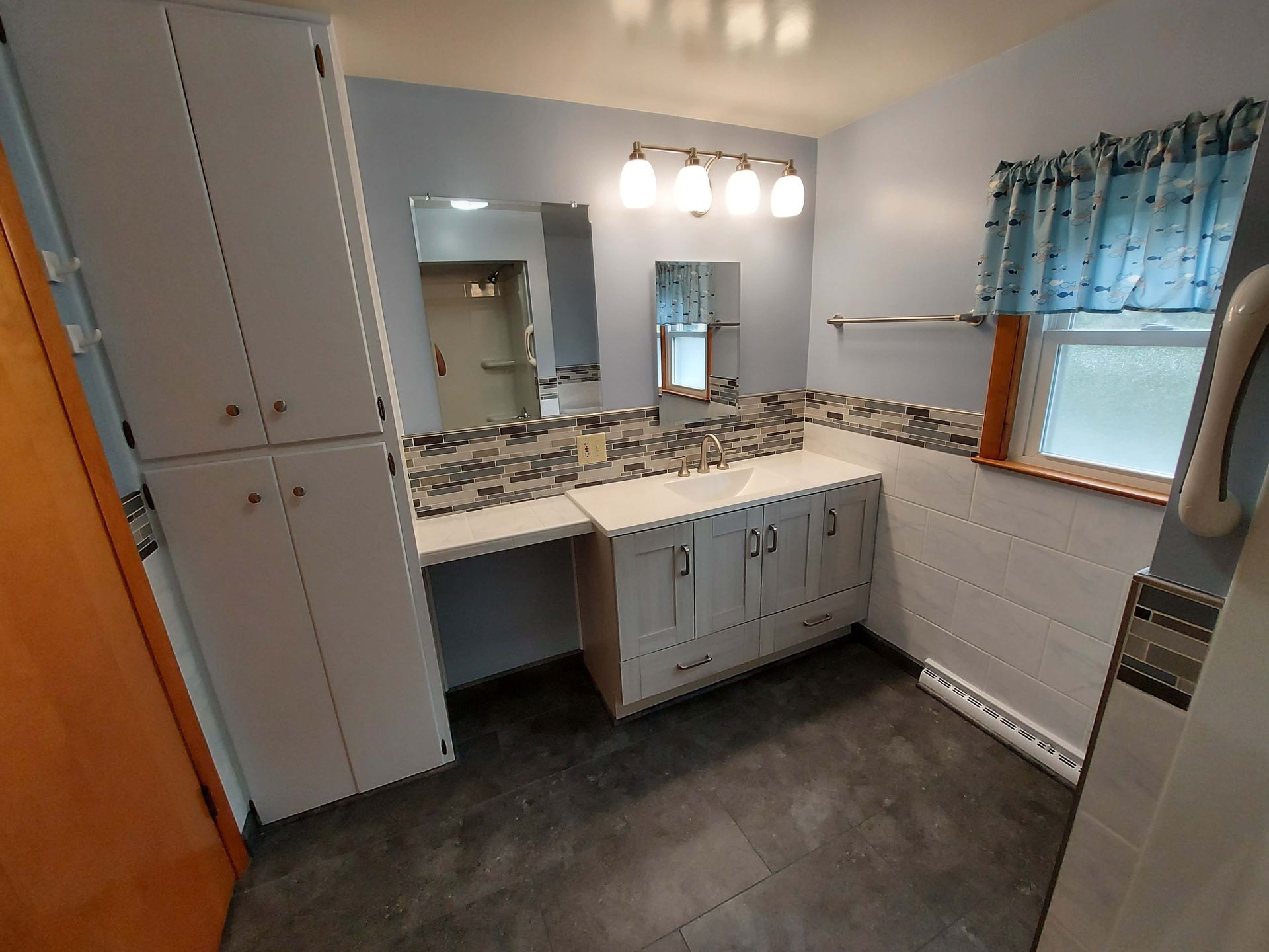 A bathroom with two sinks and a window