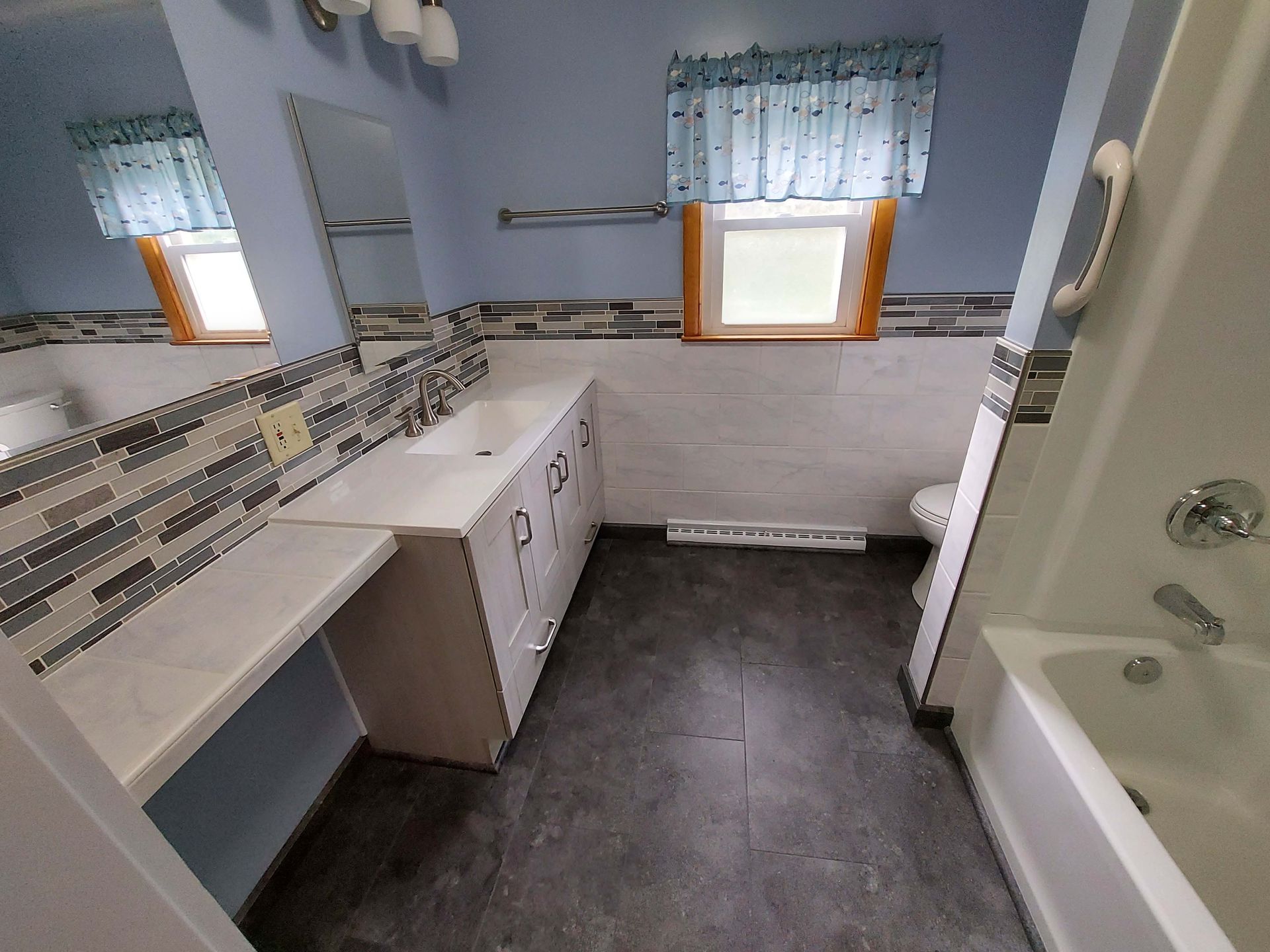 A bathroom with a sink a tub and a toilet