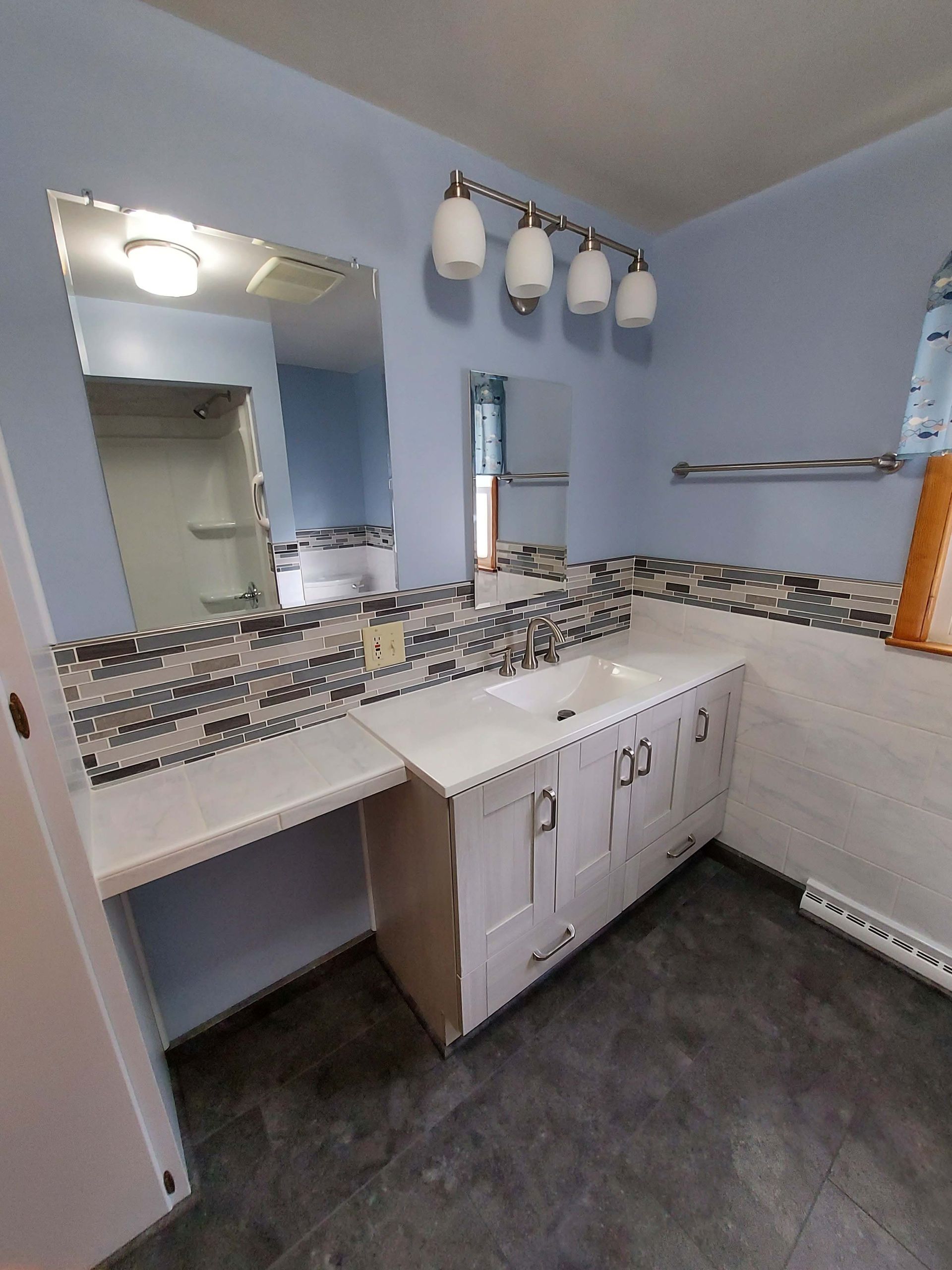 A bathroom with two sinks and a mirror