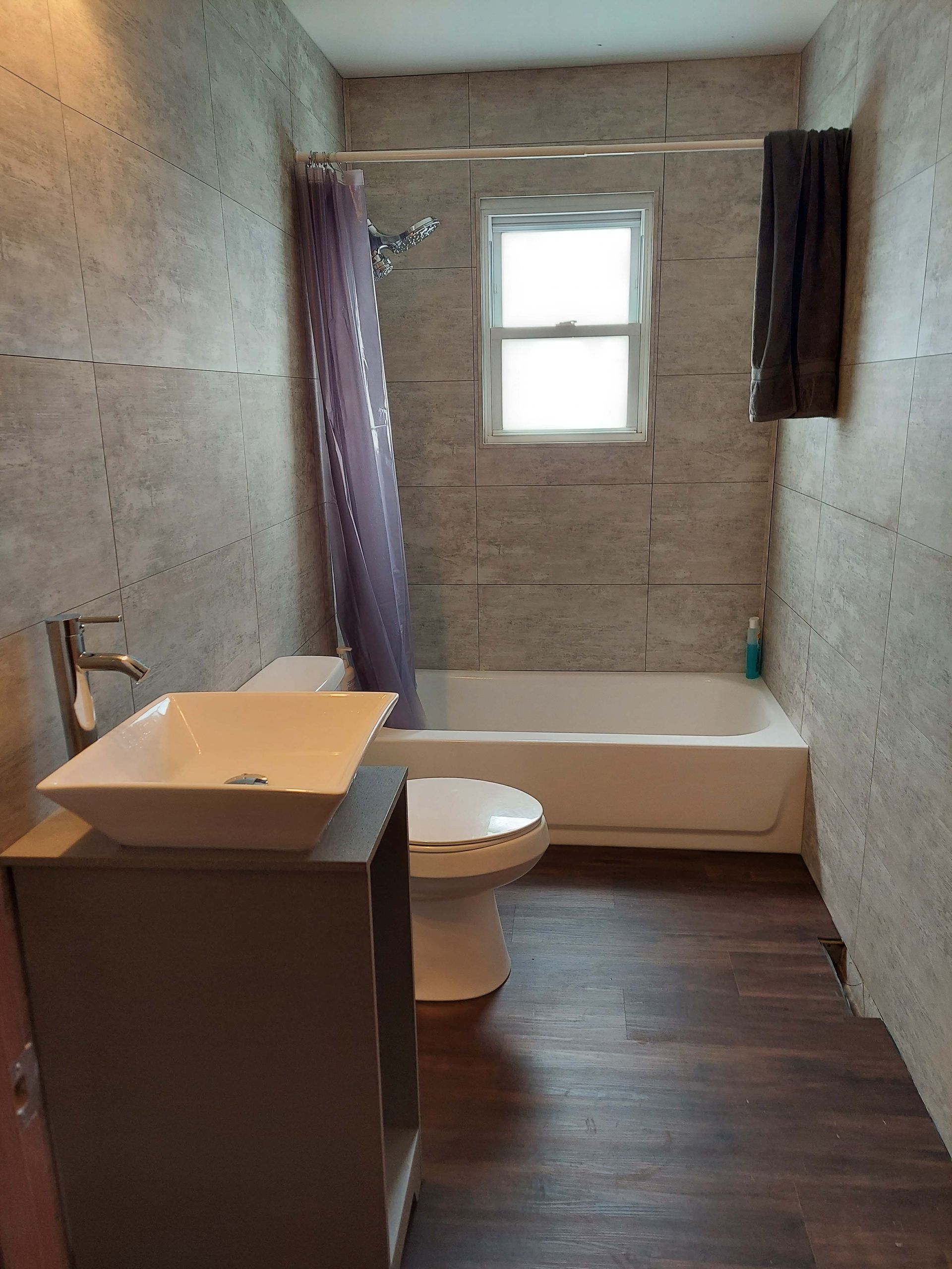 A bathroom with a sink a toilet and a bathtub