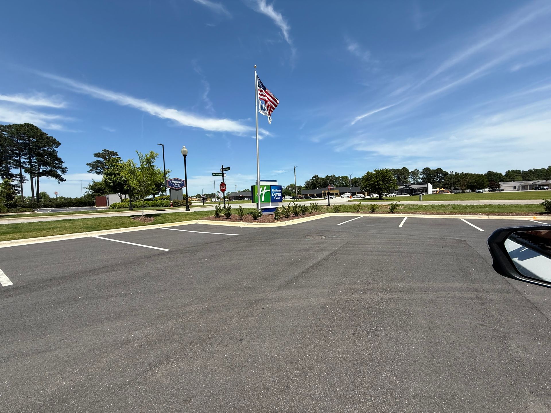 A parking lot with an american flag in the middle
