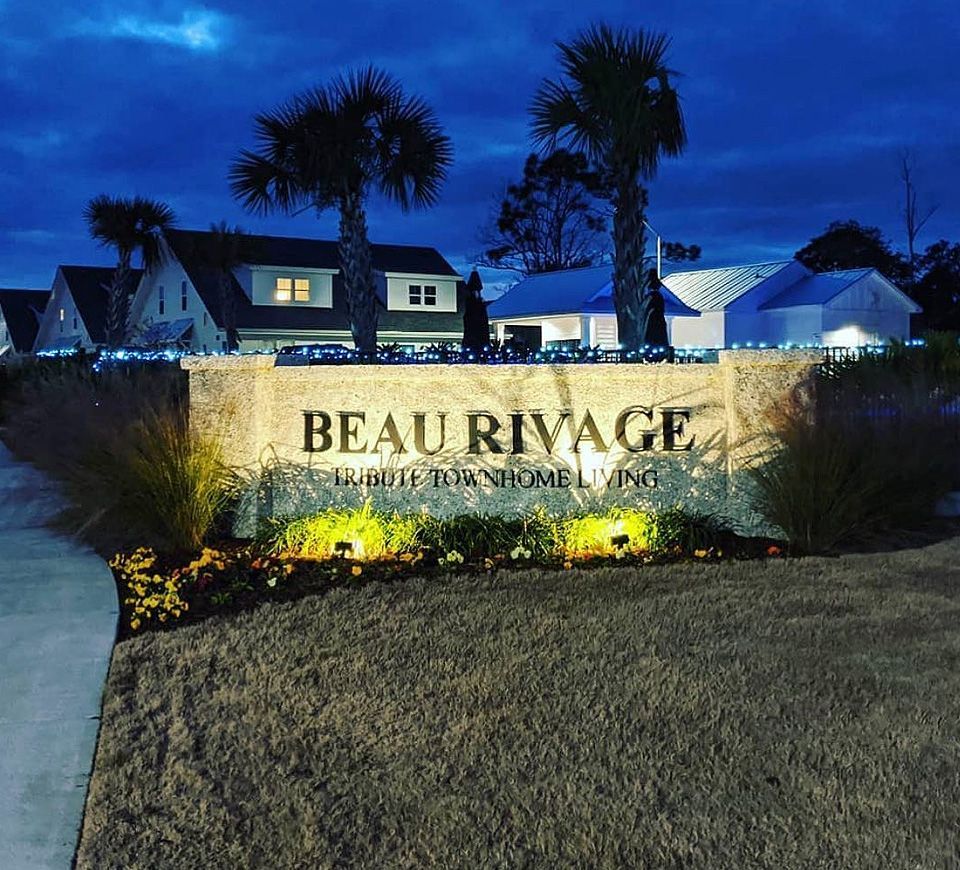 A sign lit up at night