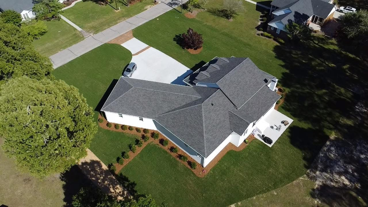 An aerial view of a house with a gray roof.