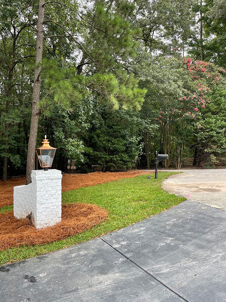 There is a mailbox in the middle of the driveway.