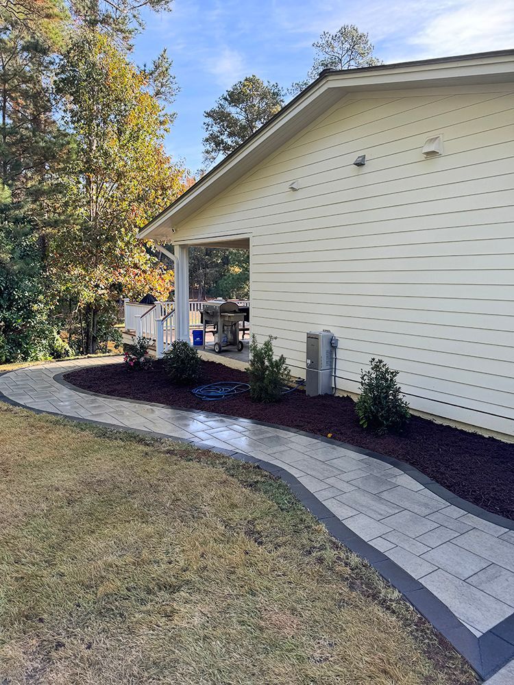 A white house with a walkway leading to it.