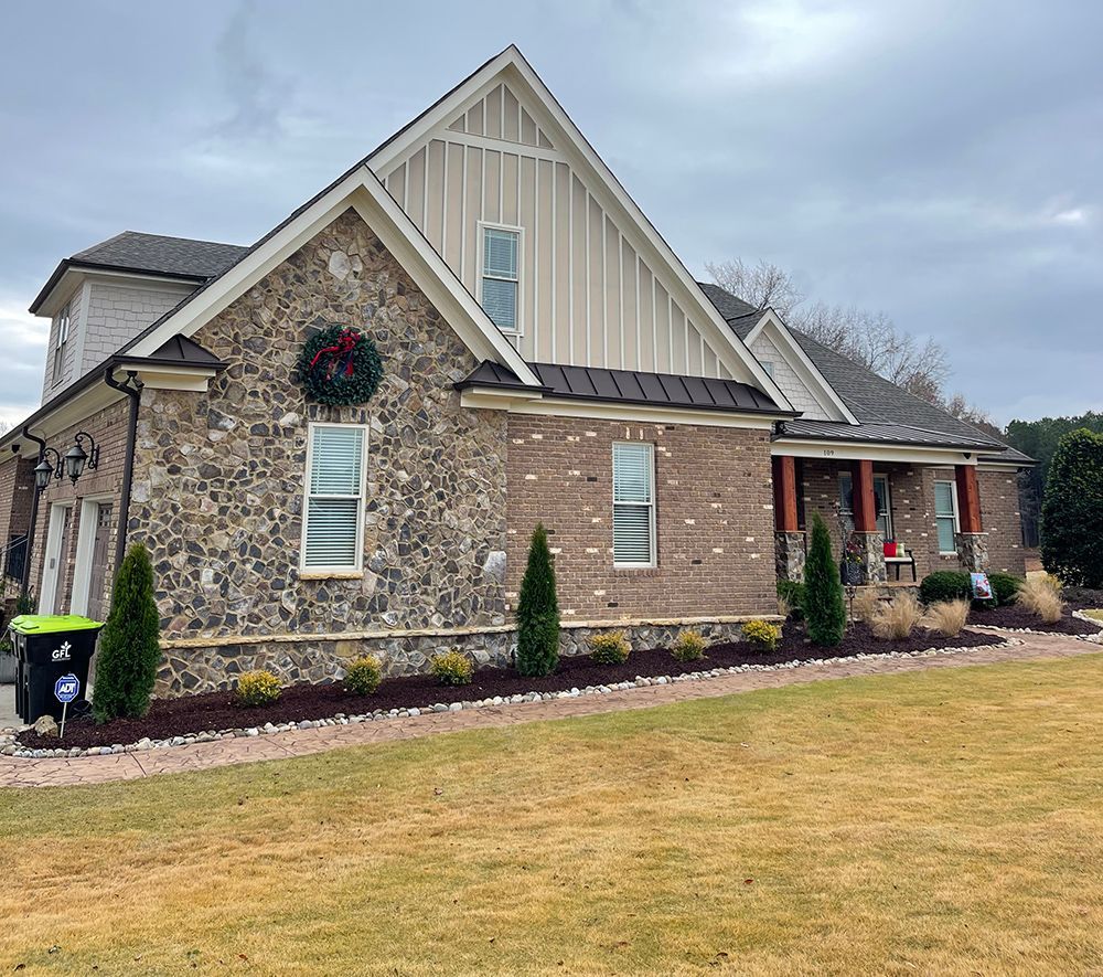 A large brick house with a wreath on the front of it