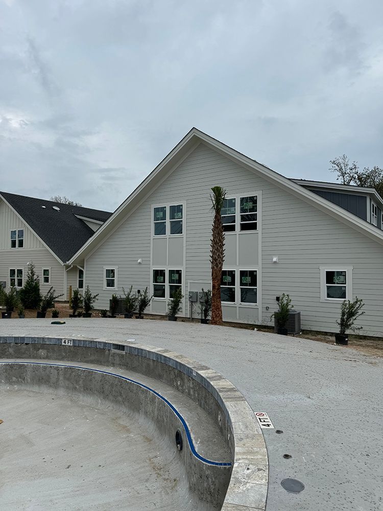 A large white house with a swimming pool in front of it