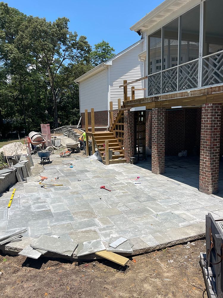 A patio is being built in front of a house.