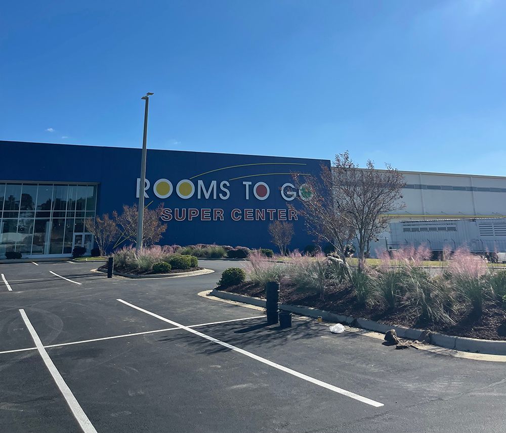 A room to go store with a parking lot in front of it