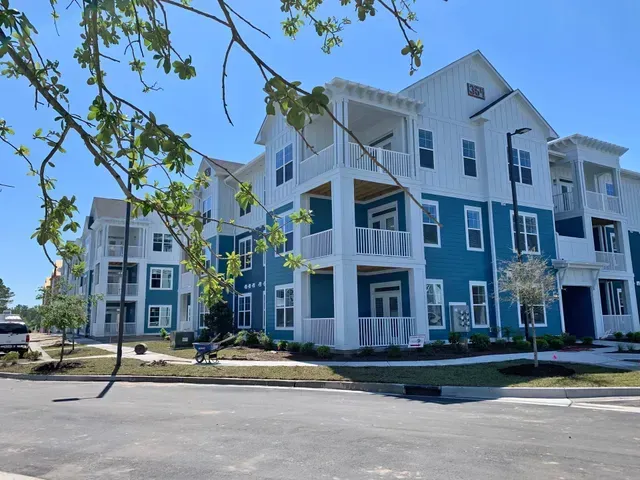 A large apartment building with a lot of windows and balconies