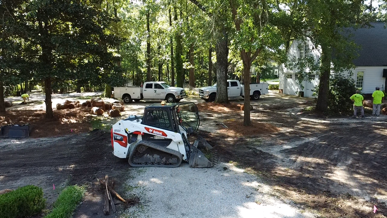A bulldozer is parked in a driveway next to a house.