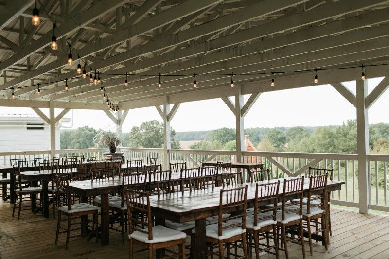 There are a lot of tables and chairs on the deck.
