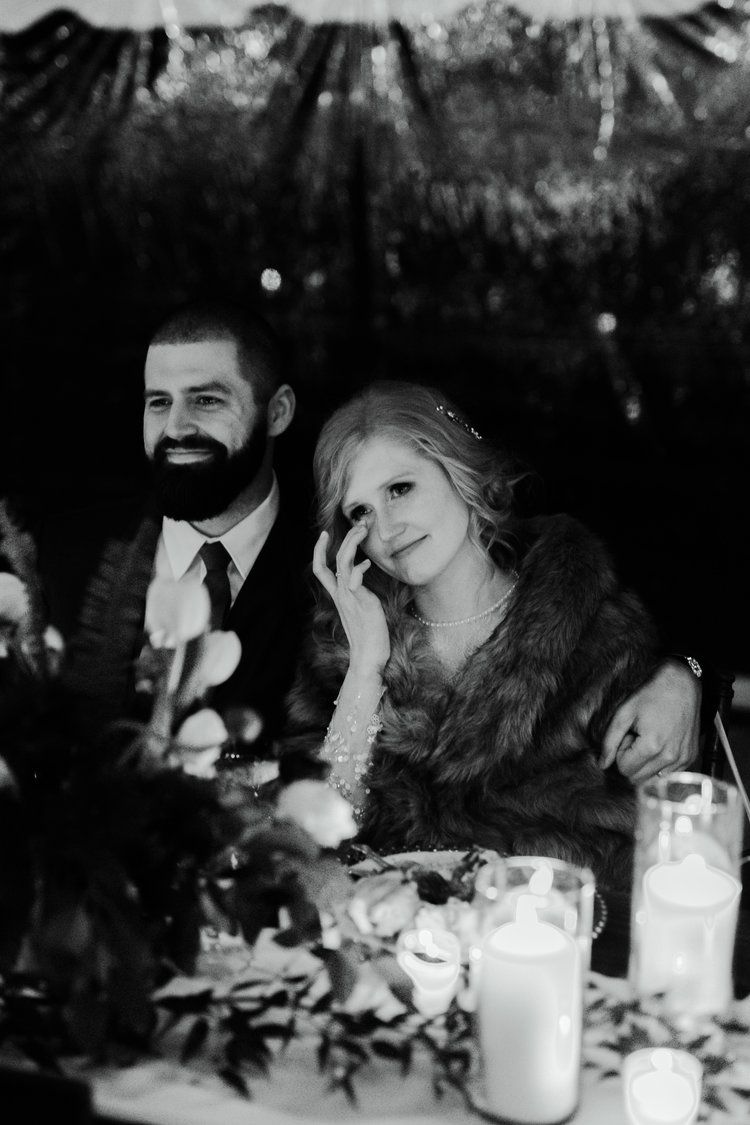 A man and a woman are sitting at a table with candles.
