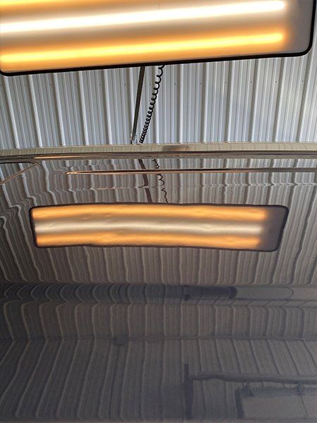 Two lights are hanging from the ceiling of a building.