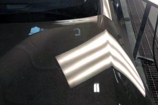 A close up of a car hood with a few lines on it