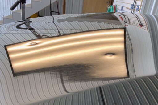 A piece of metal is sitting on top of a bed.