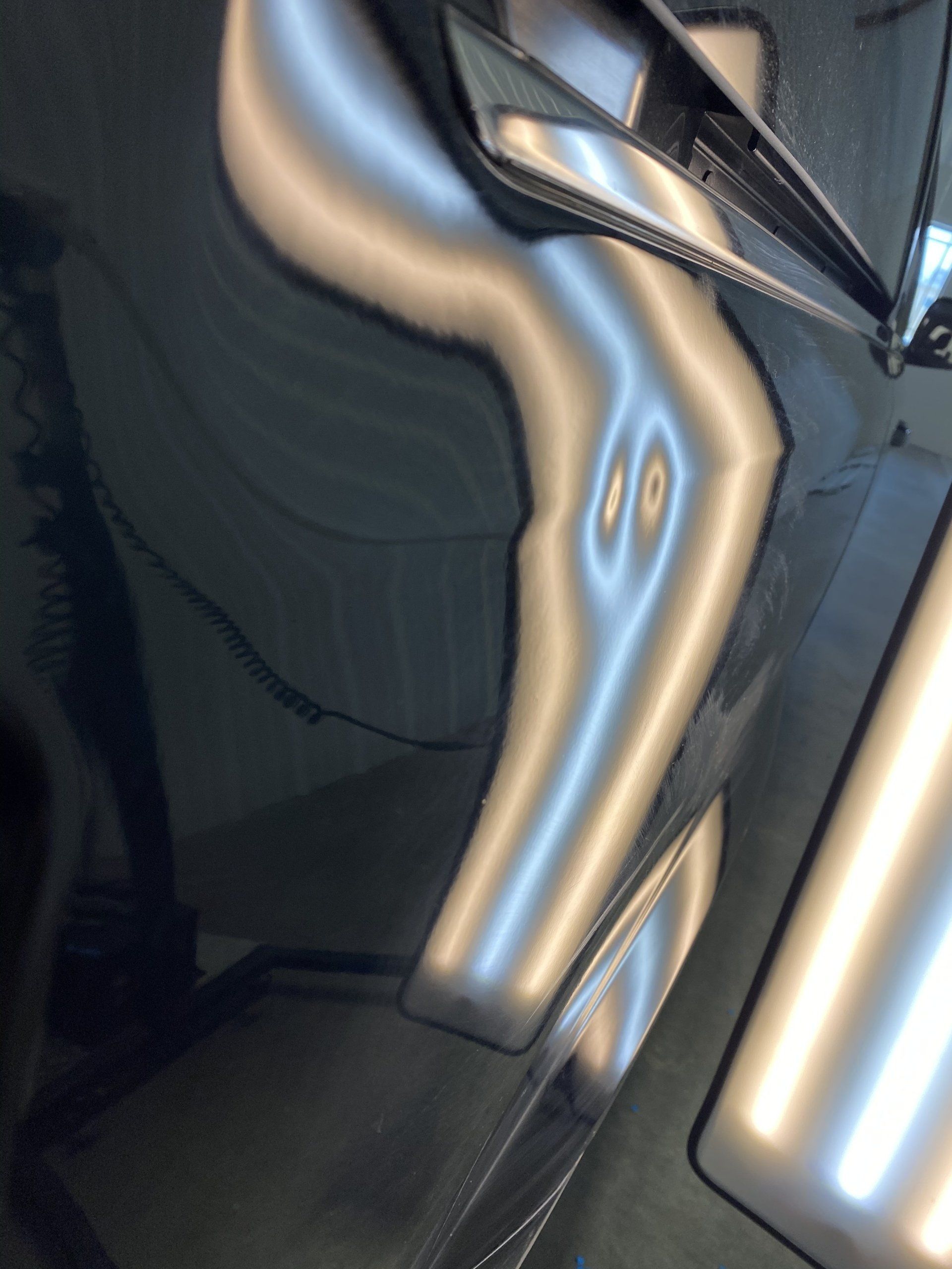 A close up of a car with dents on it