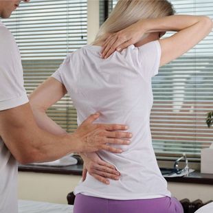 Woman patient suffering from back pain