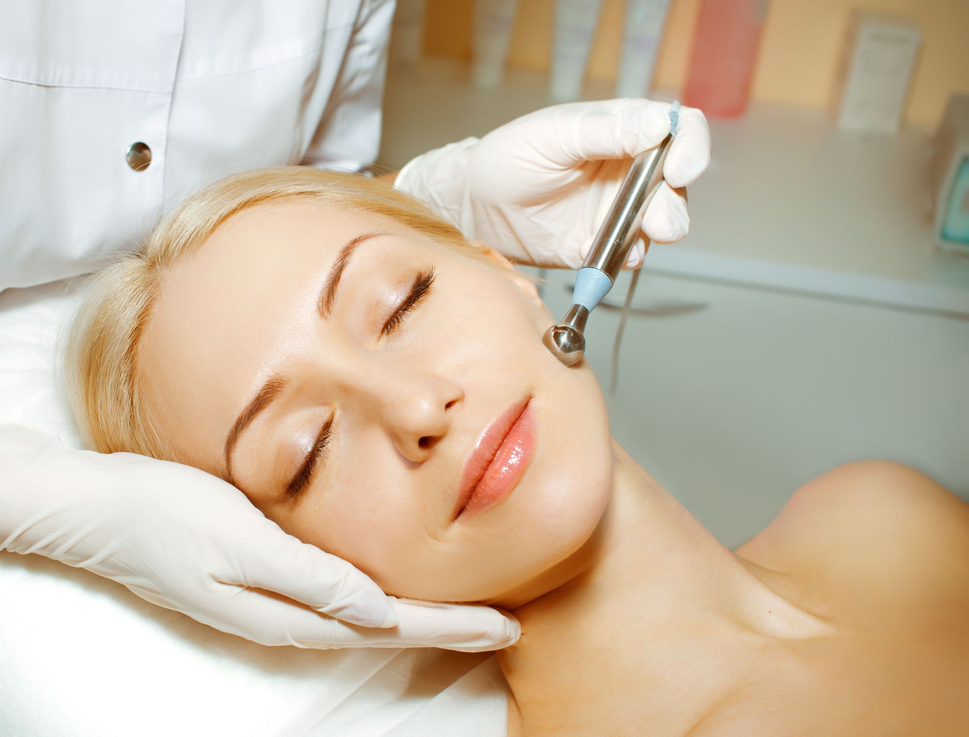 A woman is getting a facial treatment at a beauty salon.