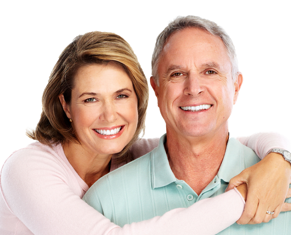 A man and a woman are hugging and smiling for the camera