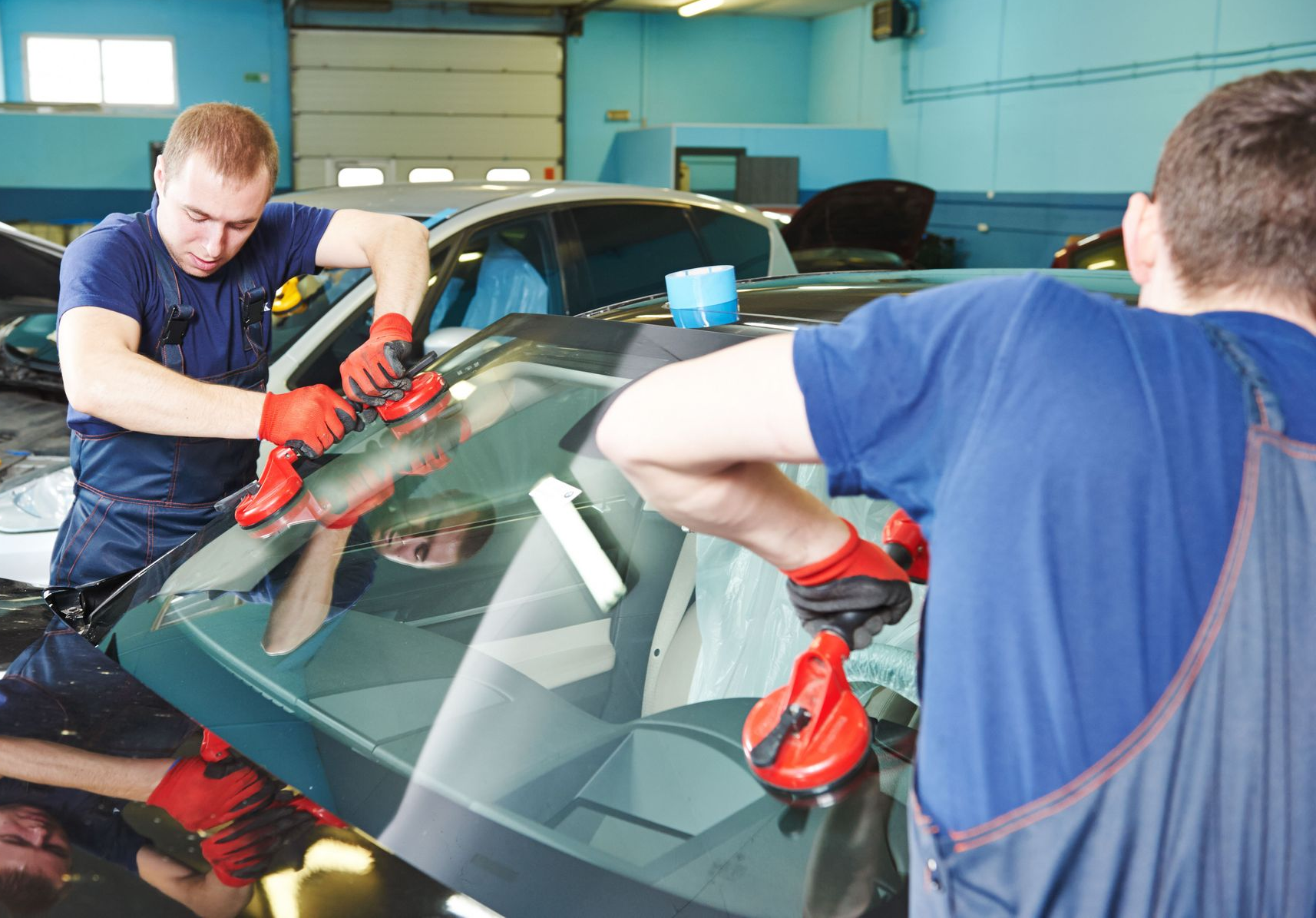 Modern building with brick facade and wood-paneled upper story, blue windows, against a light blue sky.