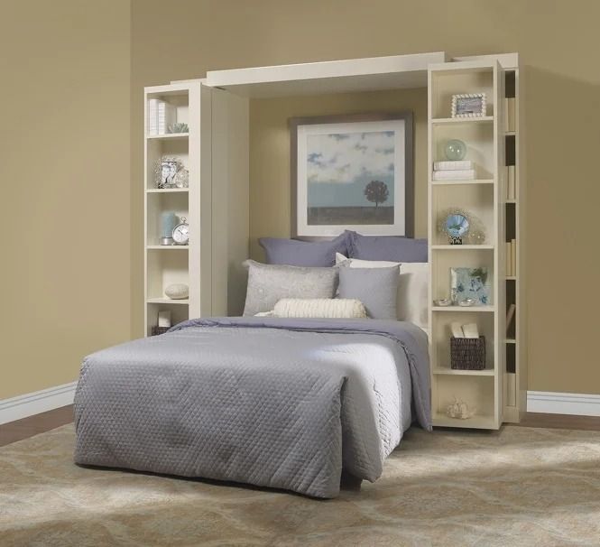 A bedroom with a bed and a picture on the wall