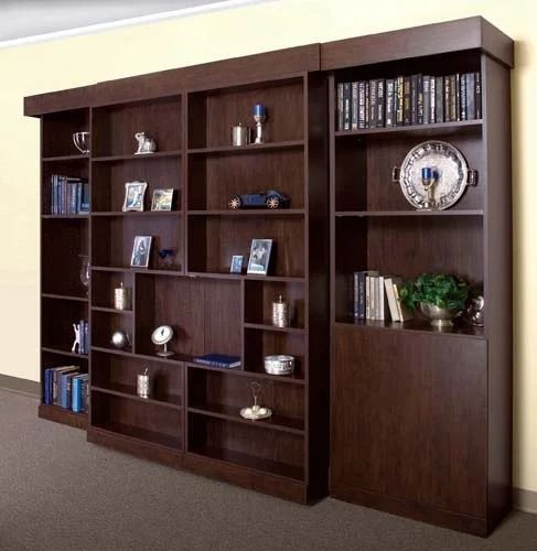 A bookshelf with a plate on top of it