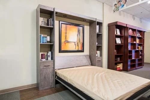 A bed that is turned into a bookshelf in a room.
