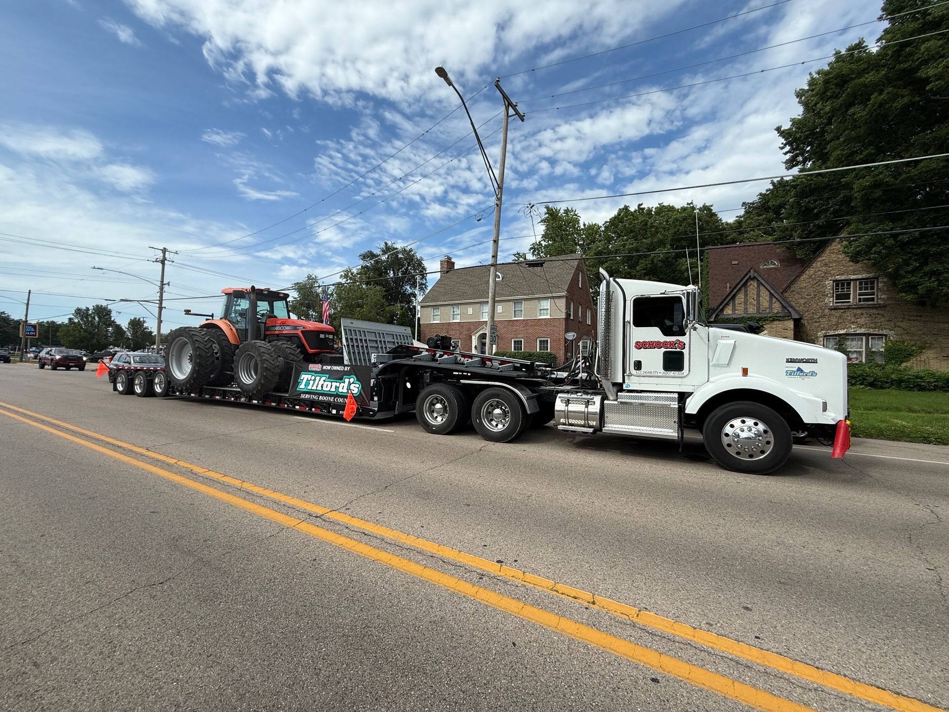 Tow truck operator securing a heavy machine in Pingree Grove, IL