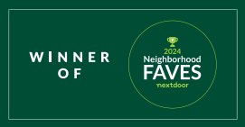 A green sign that says winner of neighborhood faves nextdoor