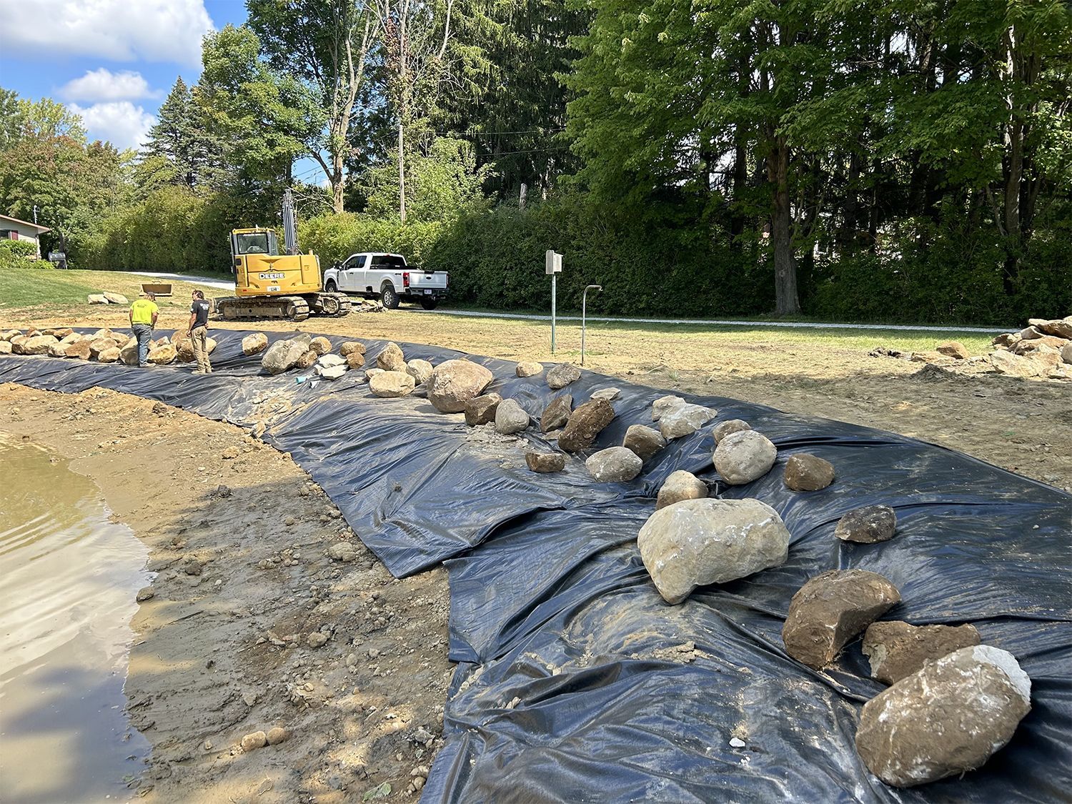 A construction site with a lot of rocks and a bulldozer in the background.