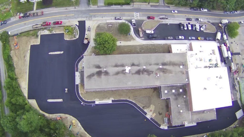 An aerial view of a building with a white roof