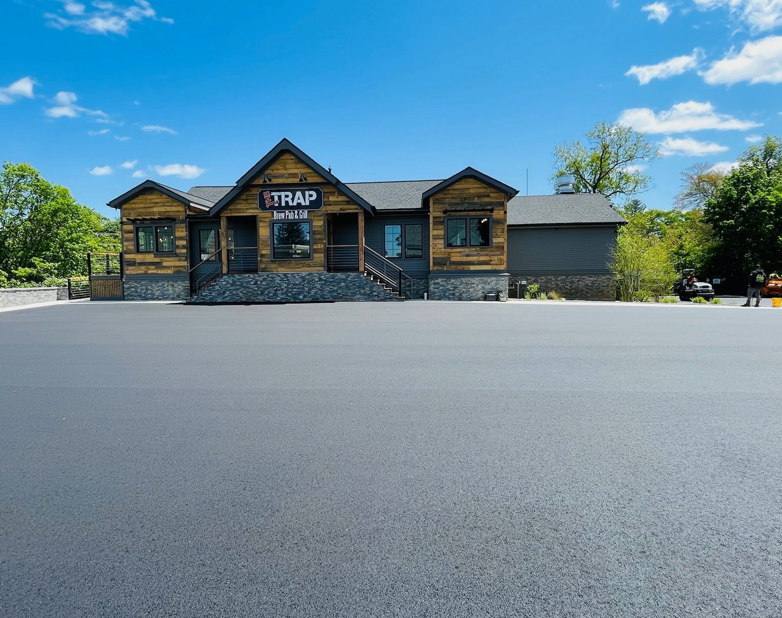 A large house with a lot of parking in front of it