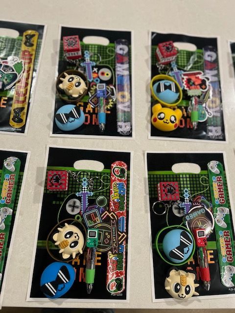 Six colorful novelty keychains on black retail cards arranged in a 2x3 grid.