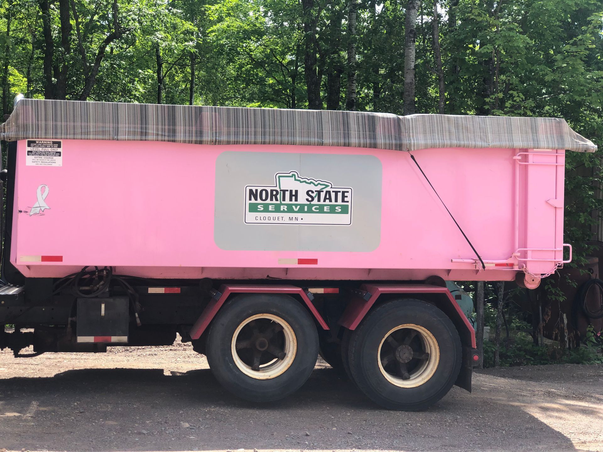 North State Services pink roll-off container truck