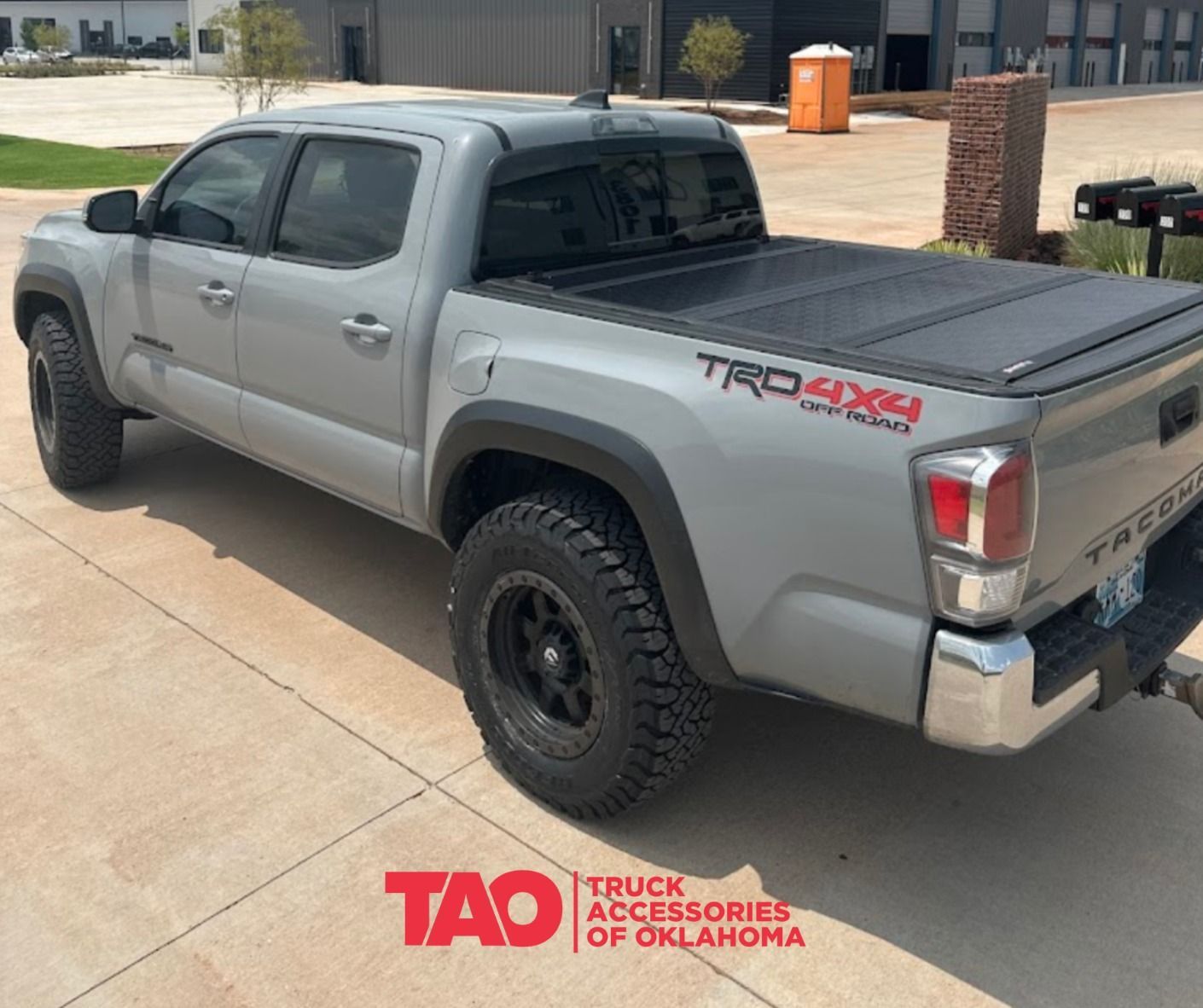 Gray Toyota Tacoma truck with black wheels and TRD Off-Road badging parked outdoors.