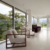 A living room with two chairs and a couch